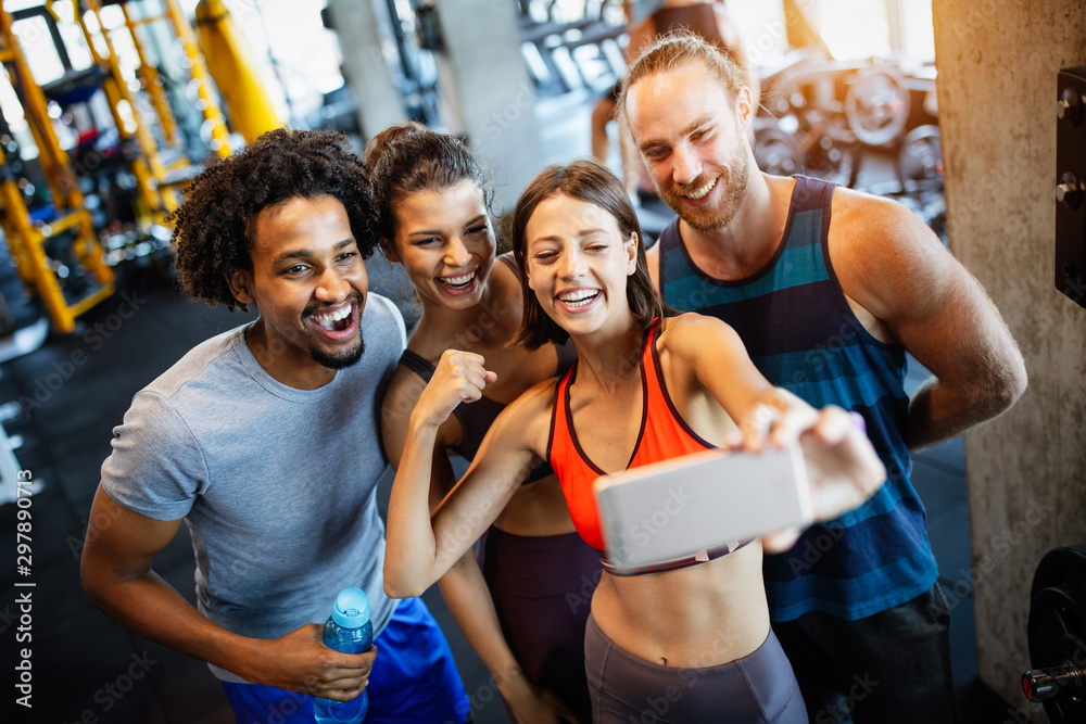 Group of sportive people in a gym taking selfie. Concepts about lifestyle and sport in fitness club - obrazy, fototapety, plakaty 