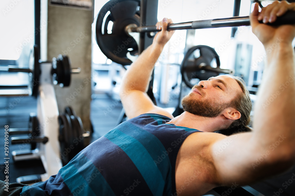 Healthy life and gym exercise. Handsome man working out in health club Healthy life and gym exercise. Handsome man working out in health club