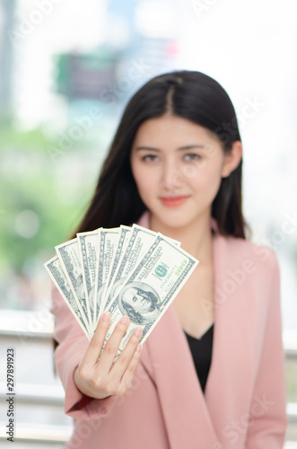 Beauitful young asian woman handing over money