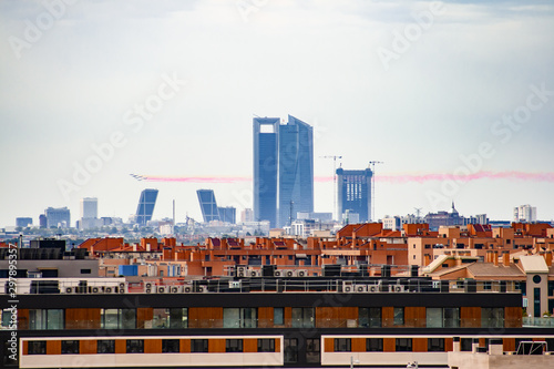 Patrol Aguila Patrulla Aguila flying over the city of Madrid on October 12 releasing red and yellow smoke forming the Spanish flag
