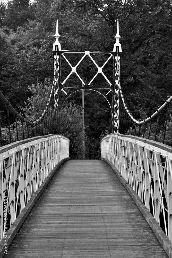 Howley suspension footbridge at victoria park passing over the river mersey. This bridge is around 100 years old and is hidden gem in warrington town, first ever taken this way. England  M
