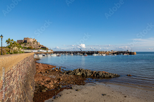 A view of Gorey harbour and castle on the island of Jersey, on a sunny day photo