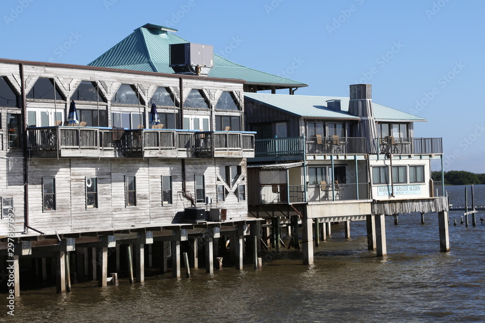 Historic waterfront buildings on stilts in Cedar Key, FL. Cedar Key is in the National Register of Historic Places since 1989.