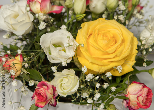 beautiful delicate floral bouquet with yellow pink shades on the background