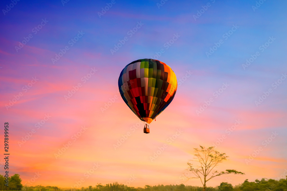 Obraz premium Multi color balloon in the sky sun set wuth forest in the down