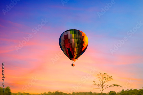 Multi color balloon in the sky sun set wuth forest in the down