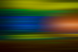 Abstract blurred multicolored horizontal lines and green orange spots background.