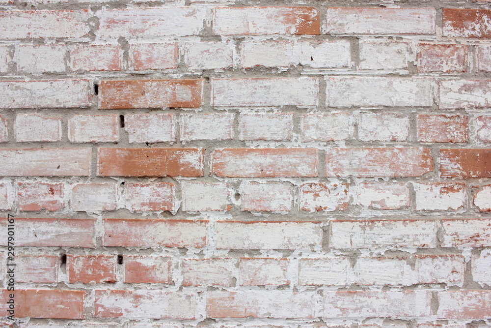 The texture of the old brick wall painted white with peeling paint.White grunge brick wall background The texture of the old brick wall painted white with peeling paint.White grunge brick wall background