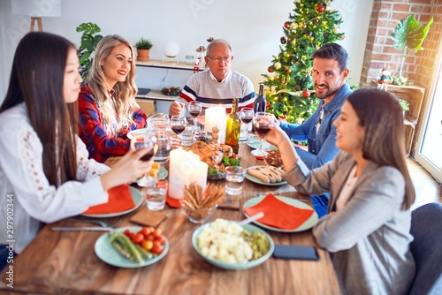 Beautiful family meeting smiling happy and confident. Eating roasted turkey celebrating Christmas at home