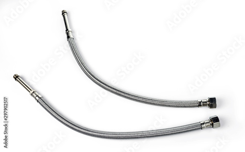Pair of flexible braided water hoses for connection to water sources. Isolated on white background.