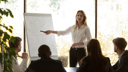 Female speaker give flip chart presentation at conference training meeting photo