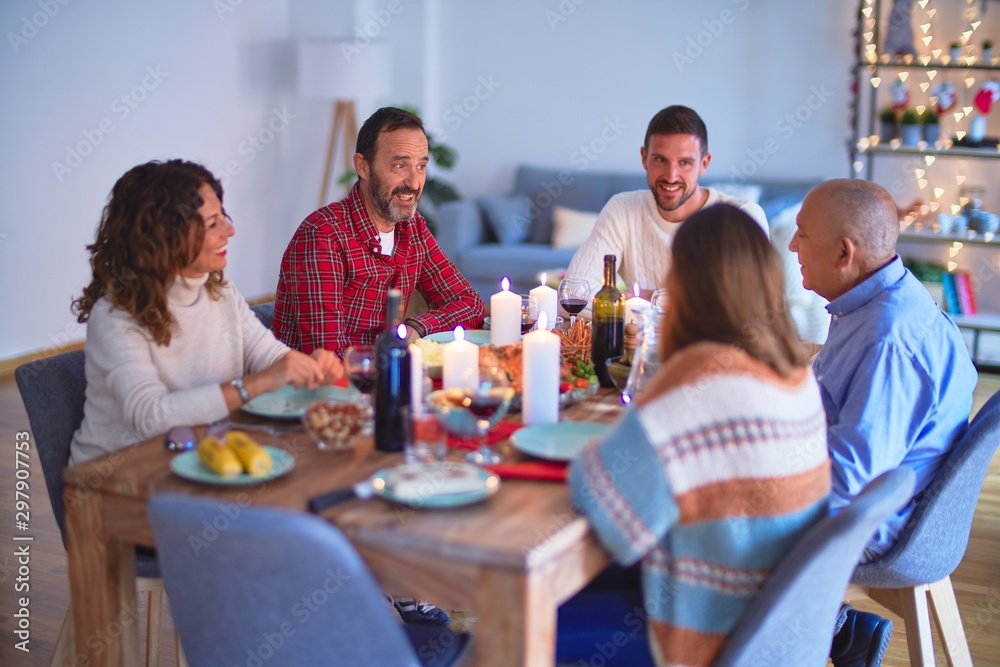 Beautiful family smiling happy and confident. Eating roasted turkey celebrating Christmas at home Beautiful family smiling happy and confident. Eating roasted turkey celebrating Christmas at home