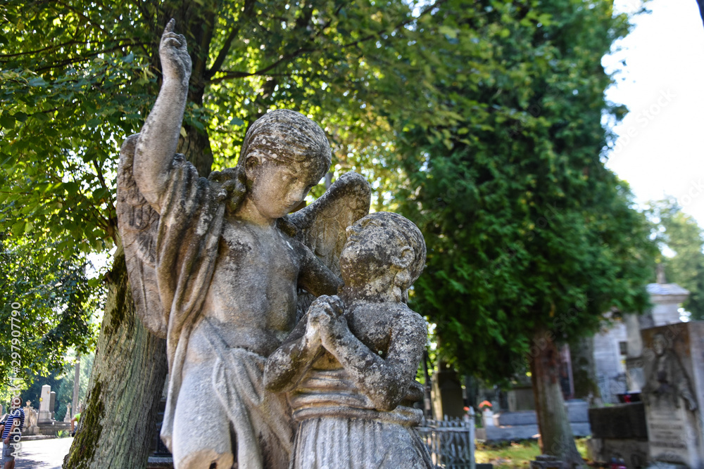 Fototapeta premium Angel statue in cemetery. Religious beliefs
