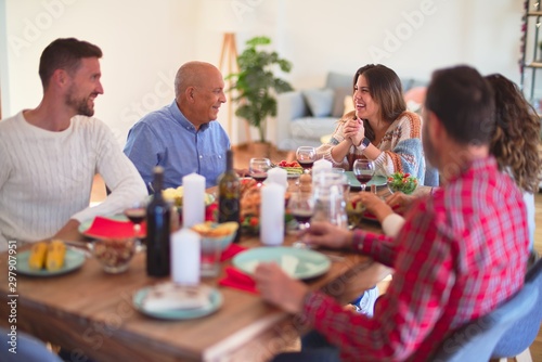 Beautiful family smiling happy and confident. Eating roasted turkey celebrating Thanksgiving Day at home