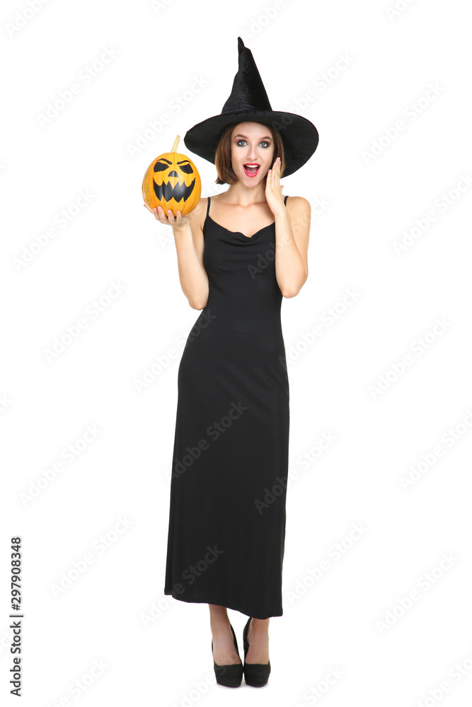 Happy young woman in black costume holding halloween pumpkin on white background