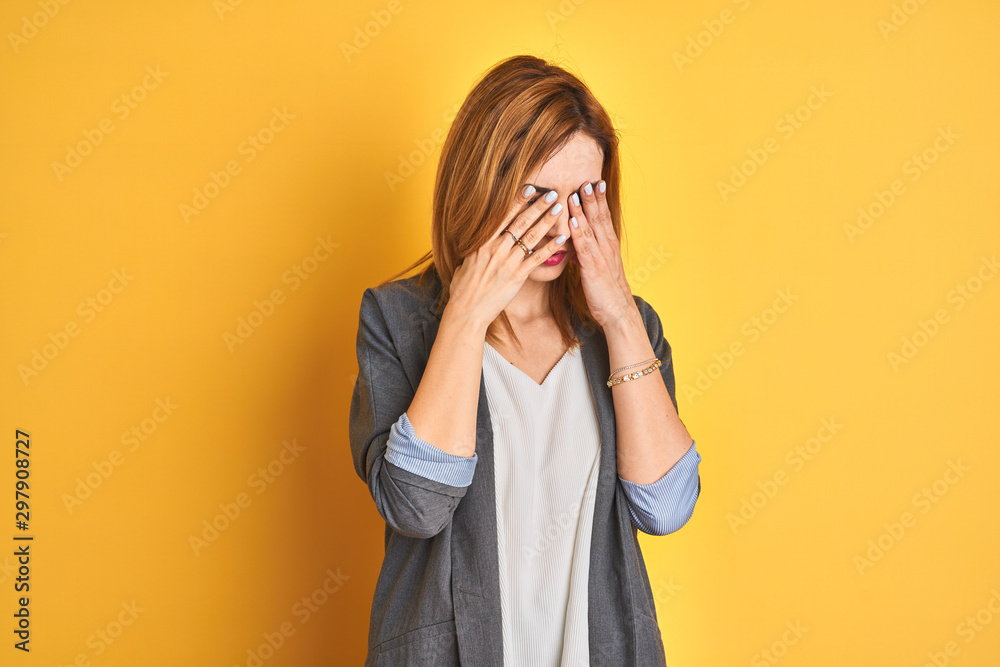 Redhead caucasian business woman over yellow isolated background confused and annoyed with open palm showing copy space and pointing finger to forehead. Think about it. Redhead caucasian business woman over yellow isolated background confused and annoyed with open palm showing copy space and pointing finger to forehead. Think about it.