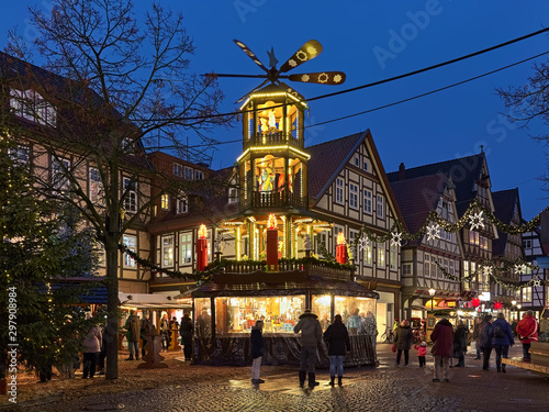Celle, Germany. Christmas pyramid at Robert-Meyer-Platz and picturesque half-timbered houses at Poststrasse with Christmas illumination in Old Town in twilight.