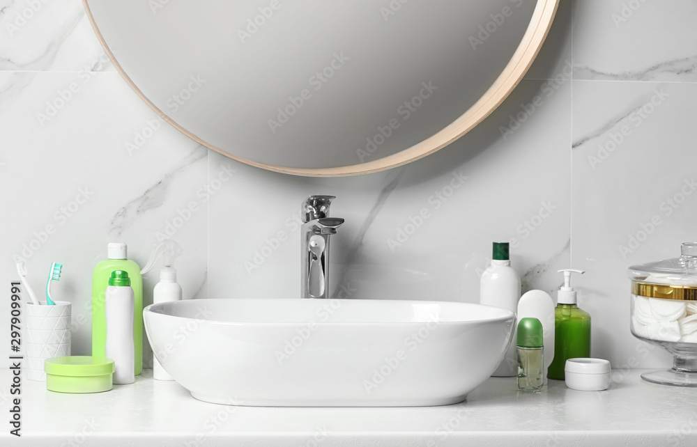 Fototapeta premium Roll-on deodorant and different toiletry on table in bathroom