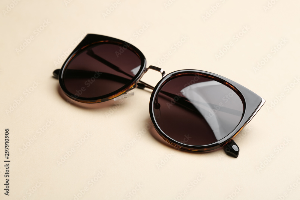 Stylish sunglasses on beige background. Fashionable accessory Stylish sunglasses on beige background. Fashionable accessory