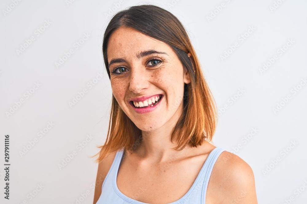 Beautiful redhead woman standing over isolated background with a happy face standing and smiling with a confident smile showing teeth