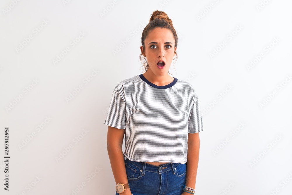 Young redhead modern woman wearing a bun over isolated background afraid and shocked with surprise expression, fear and excited face. Young redhead modern woman wearing a bun over isolated background afraid and shocked with surprise expression, fear and excited face.