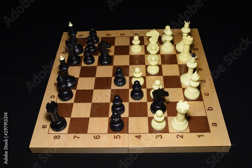 Wooden chess board and the chessmen as a strategy concept