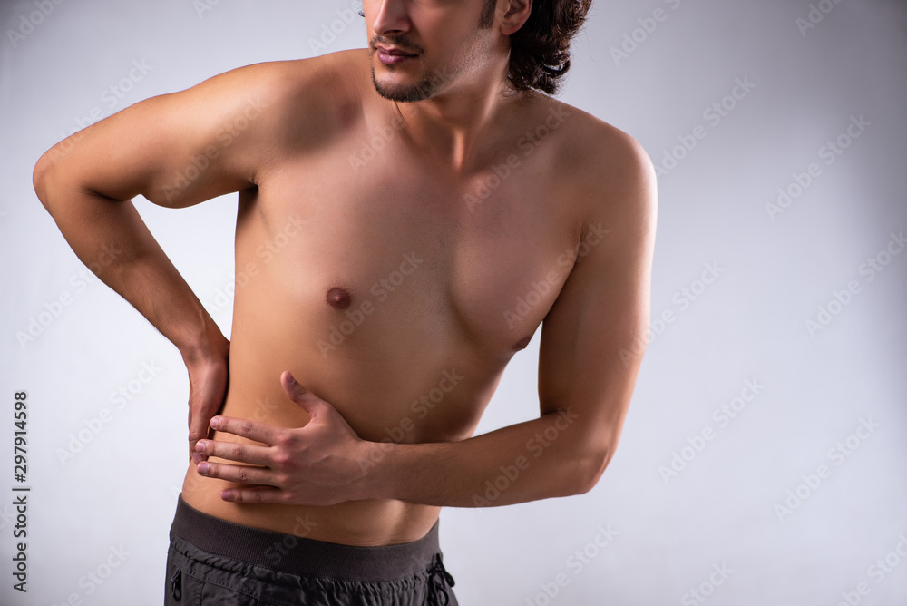 Fototapeta premium Young man suffering from stomachache