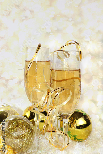 Champagne with bright ribbon and holiday decorations, Christmas and New Year background with bokeh lights, place for text. New Year card for congratulations, selective focus, banner for displaying 