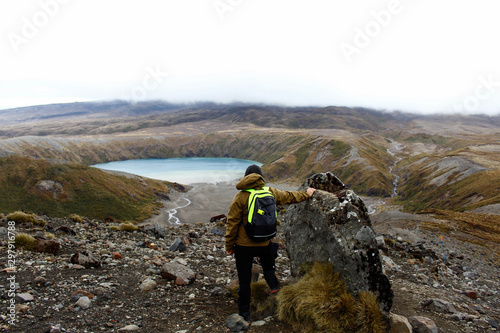 Man watching Lower Tama Lake, Ngauruhoe Mountain trek, Tongariro National Park, New Zealand, North Island