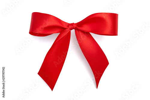 Flat lay simple holiday gift bow made of bright red shiny satin ribbon with a light gray soft shadow isolated on white background