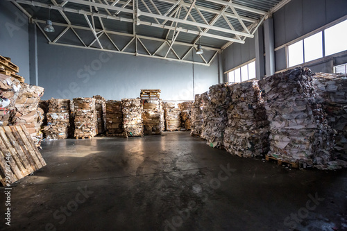 Paper pressed bales at the modern waste hazardous processing plant. Separate garbage collection. Recycling and storage of waste for further disposal. Business for sorting and processing of waste.