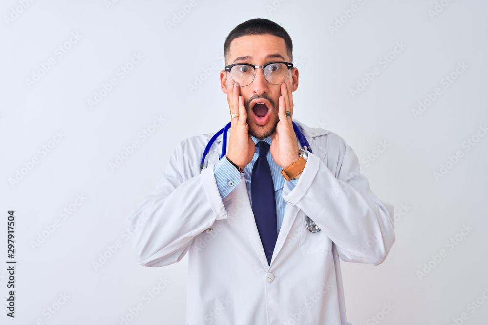 Young doctor man wearing stethoscope over isolated background afraid and shocked, surprise and amazed expression with hands on face Young doctor man wearing stethoscope over isolated background afraid and shocked, surprise and amazed expression with hands on face