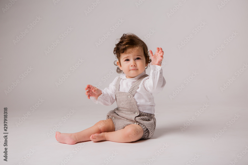 baby girl curly brunette 6 months on white background, space for text baby girl curly brunette 6 months on white background, space for text