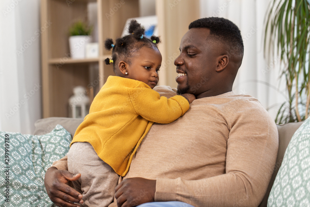 family, fatherhood and people concept - happy african american father with baby daughter at home family, fatherhood and people concept - happy african american father with baby daughter at home
