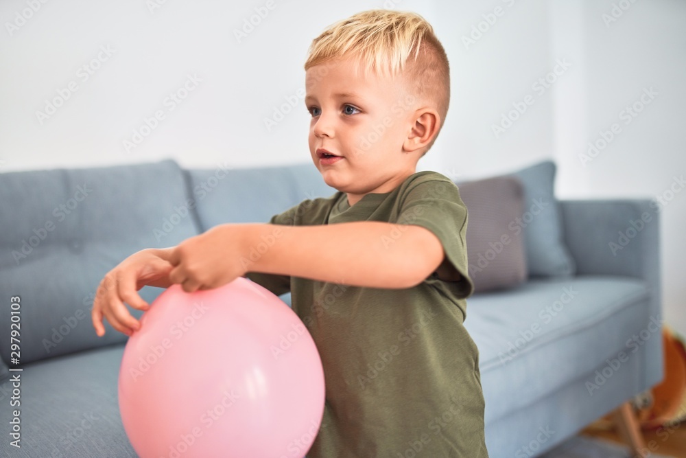 Young caucasian kid playing at kindergarten with toys. Preschooler boy happy at playroom. Young caucasian kid playing at kindergarten with toys. Preschooler boy happy at playroom.