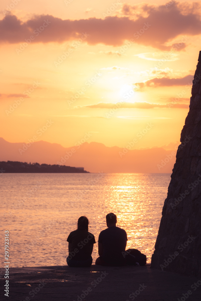 people enjoy the sunset in Cefalu, Sicily