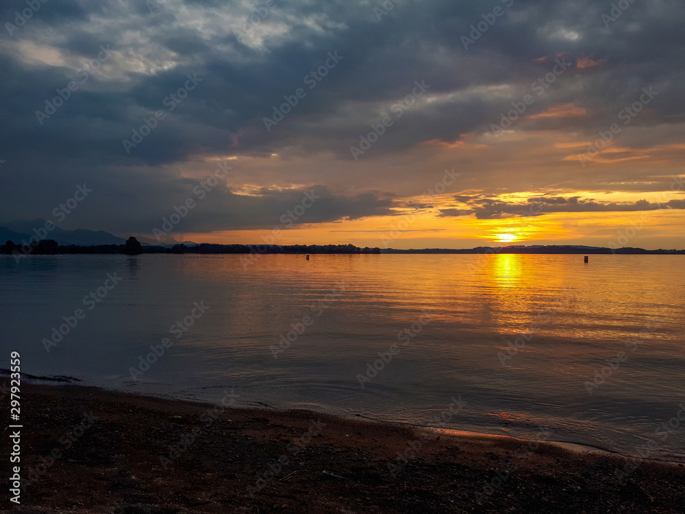 Golden sunset at the sandy beach of lake Chiemsee
