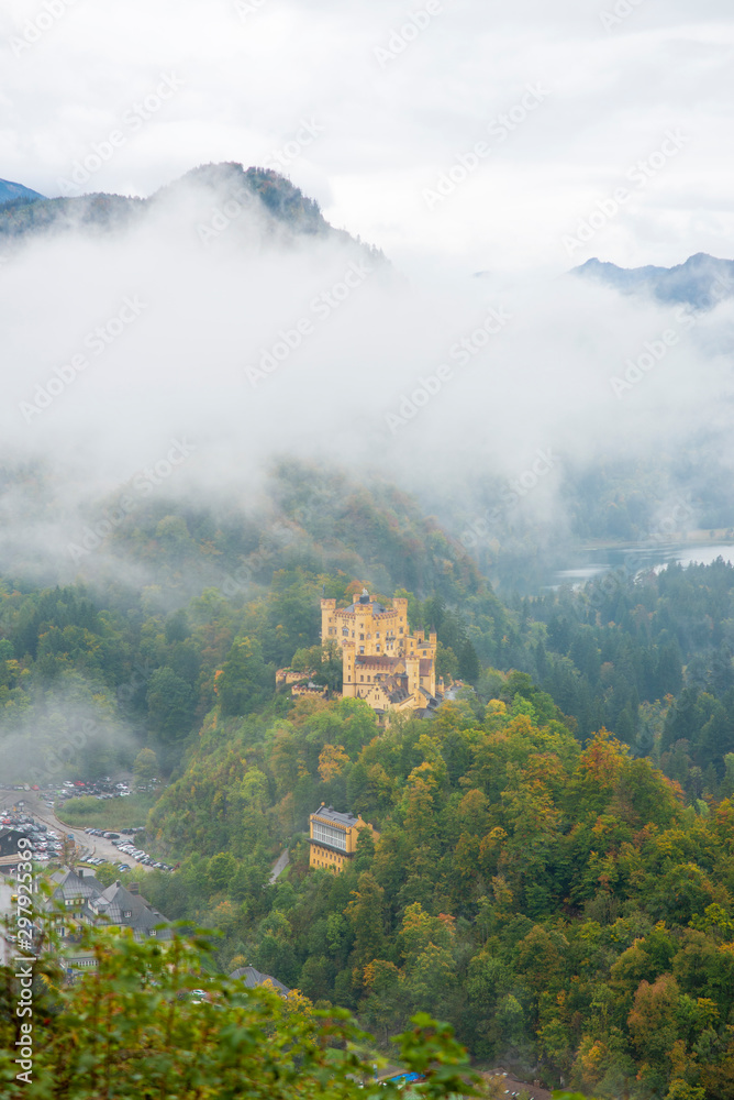 Hohenschwangau castle in autumn with fog in the morning