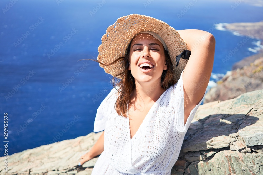 Young beautiful woman enjoying summer vacation on mountain landscape, traveler girl smiling happy with ocean view