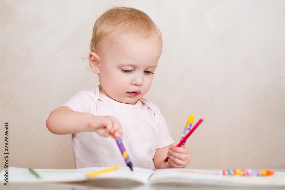 kid ineptly draws in the album with colored pencils kid ineptly draws in the album with colored pencils