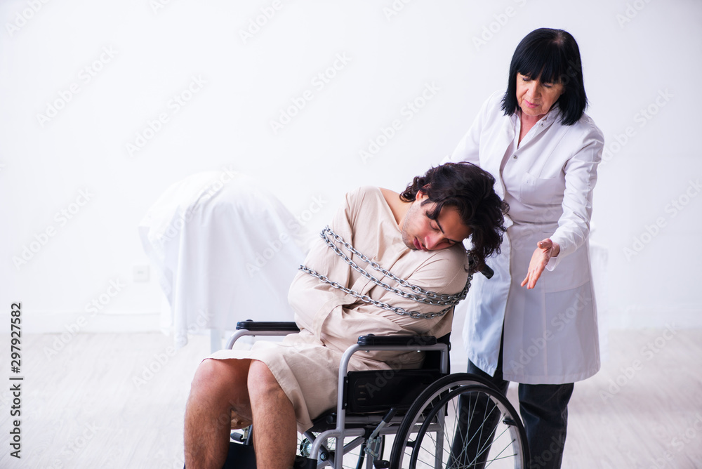 Old female psychiatrist visiting young male patient Old female psychiatrist visiting young male patient