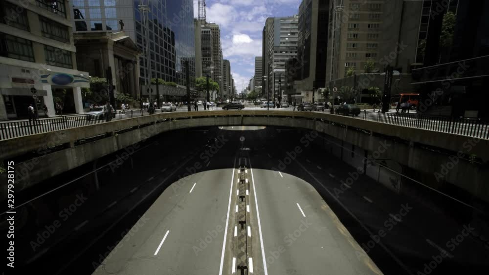 Wide view of a bridge, vehicles and people passing in the most important avenue in sao Paulo, Av Paulista. Brazil