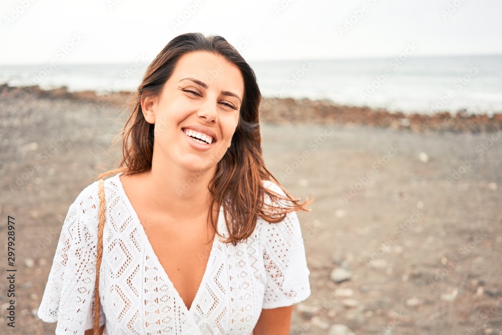 Young beautiful woman smiling happy enjoying summer vacation at black sand beach at Canary Islands Young beautiful woman smiling happy enjoying summer vacation at black sand beach at Canary Islands