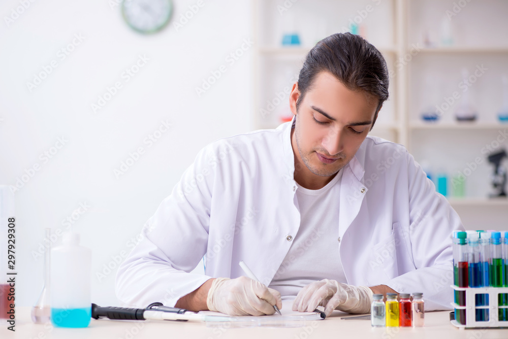 Young male chemist working in the lab Young male chemist working in the lab