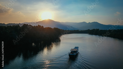 Vászonkép Beautiful Drone Shot of a Boat on the Prek Kampot River at Sunset during a River Cruise in Kampot, Cambodia