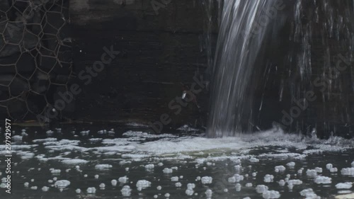 Small waterfall in the autumn park, close-up