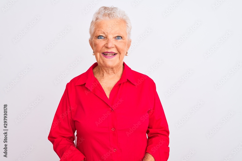 Senior grey-haired woman wearing red casual shirt standing over isolated white background with a happy and cool smile on face. Lucky person.
