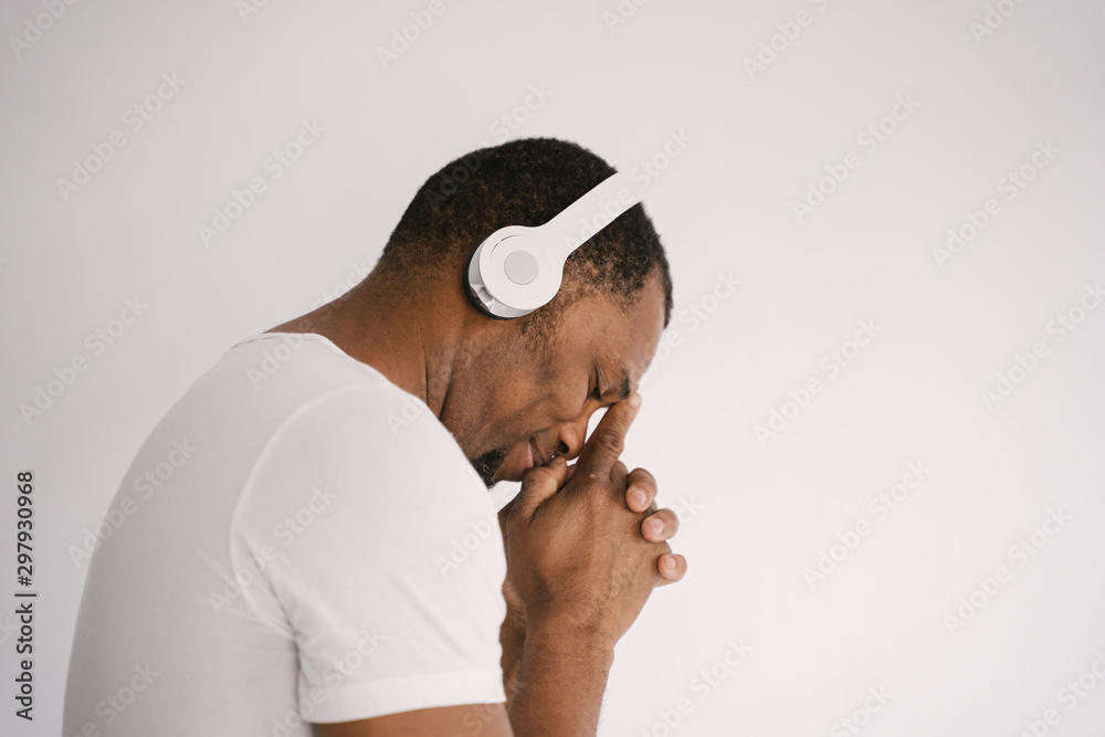 Portrait of a smiling african american man listening to music on