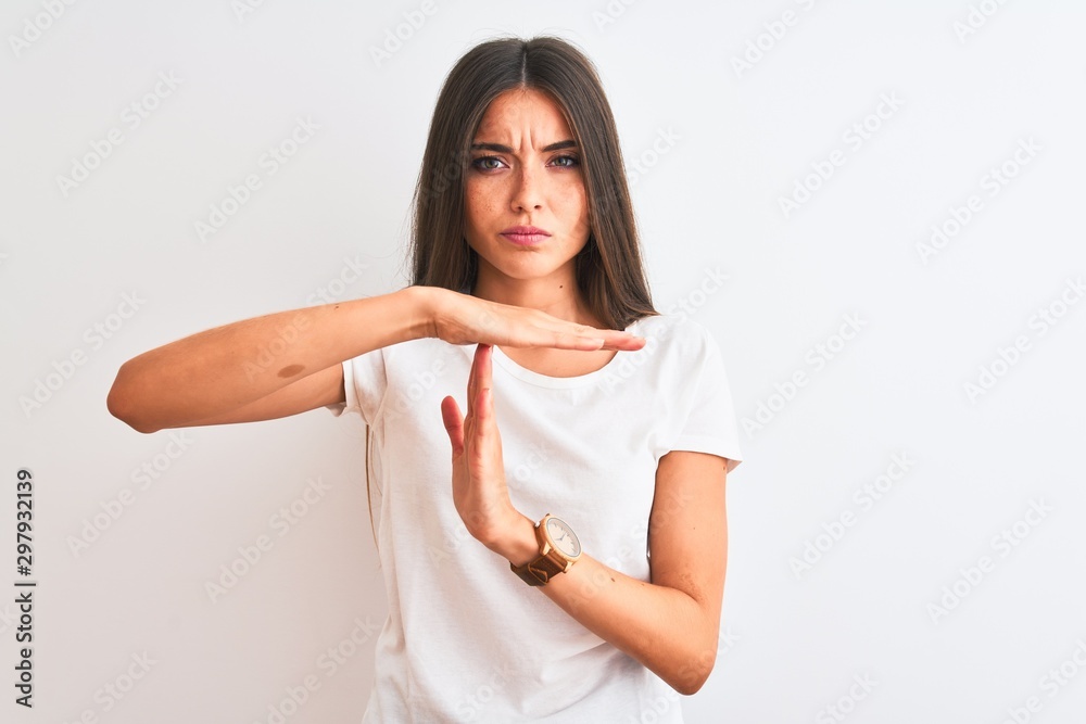 Young beautiful woman wearing casual t-shirt standing over isolated white background Doing time out gesture with hands, frustrated and serious face Young beautiful woman wearing casual t-shirt standing over isolated white background Doing time out gesture with hands, frustrated and serious face