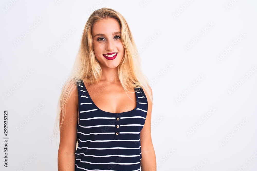 Young beautiful woman wearing casual striped t-shirt standing over isolated white background with a happy and cool smile on face. Lucky person.